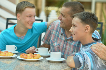 father and sons having breakfast