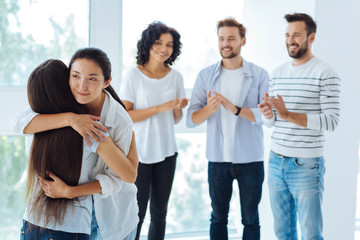 Positive nice women hugging each other