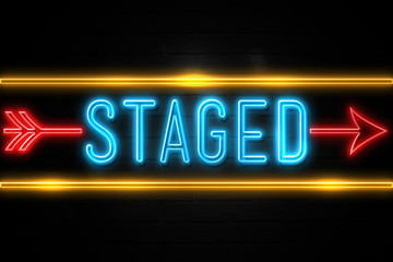 Staged  - fluorescent Neon Sign on brickwall Front view