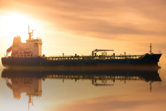 Chemical tanker ship is anchored at smooth sea.