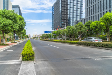 Fototapeta premium city road through modern buildings
