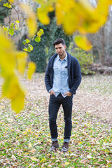 Handsome man in the park. Autumn scenery.yellow leafs