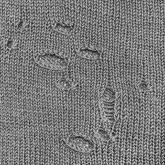 The surface of a wool knit article in holes in the form of a background