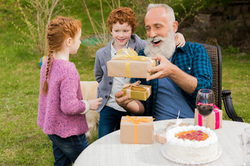 kids greeting grandfather at birthday celebration