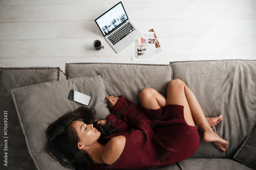 Wall mural top view of a beautiful asian woman in sweater sleeping