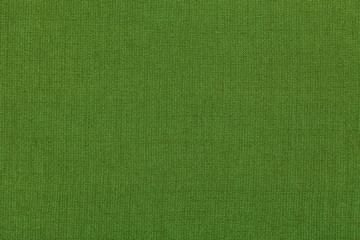 Green background from a textile material with pattern, closeup. Structure of the fabric with...