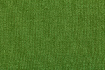 Green background from a textile material with pattern, closeup. Structure of the fabric with natural texture. Cloth backdrop.