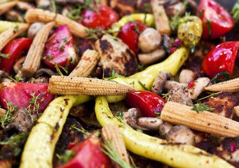 Vegetables baked on the grill: corn, mushrooms, tomatoes, beef, bell pepper, greens