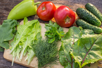 Fresh ingredients for a vegetarian salad with vegetables and greens