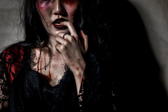 Zombie women death or witch the ghost drain hand blood skin is screaming darkness and nightmare, horror of scary fear on hell is monster in halloween festival concept,copy space the right.