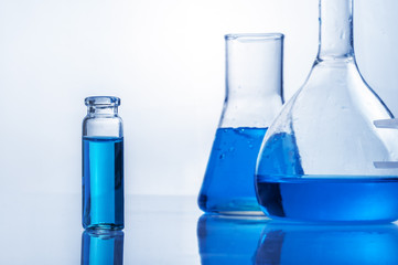 Science laboratory test tubes, equipment filled with blue liquid