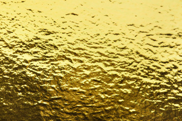 Gold foil leaf shiny wrapping paper texture background for wall paper decoration element