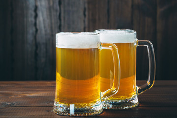Mug of beer on the wooden background