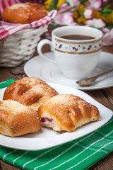 Buns with berries on a wooden table.