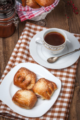 Buns with berries on a wooden table.