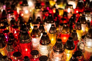 Burning candles at a cemetery during All Saints Day