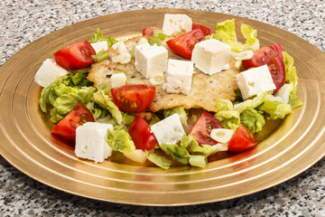 potato pancake, mediterranean style with tomato, salad and goat cheese