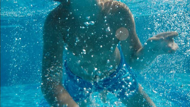 teen boy learns how to swim