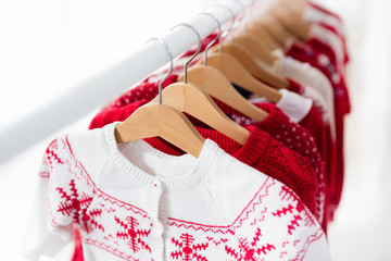 Clothes rack with red Christmas knit wear