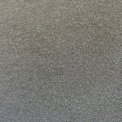 Rough stucco textured background of a wall with natural light. Abstract texture of plaster.