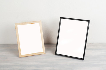 Photo frames on wooden table. Decor.