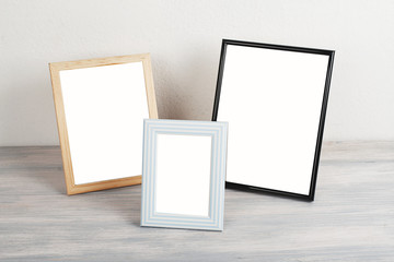 Photo frames on wooden table. Decor.