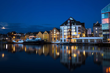 Fototapeta na wymiar Night view of Alesund. Beautiful lights and reflections in sea. Norway