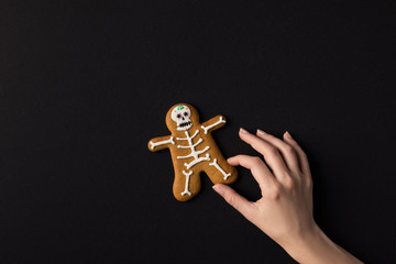 hand with halloween cookie