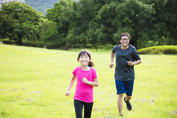 happy little girl Running In Countryside With Father.