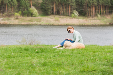 woman with dog on grass