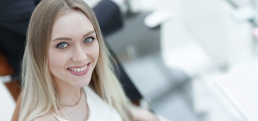 young business woman sitting at a desk in the office .