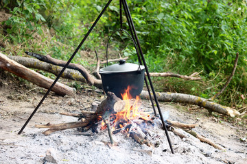 Cooking food in summer on nature at stake in cauldron