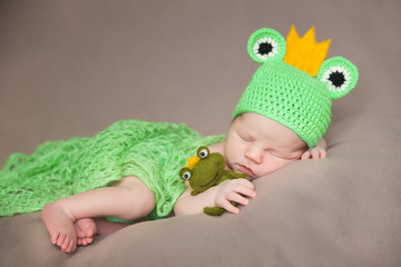 cute newborn baby in a frog costume
