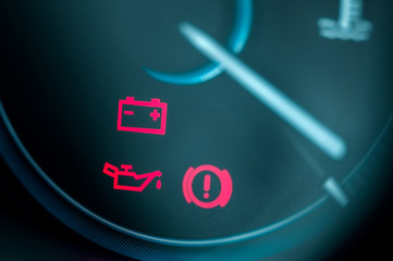 Close-up on car dashboard and warning icon
