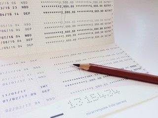 Obraz premium Business, finance, saving money or investment concept : Saving account book or financial statement on desk table