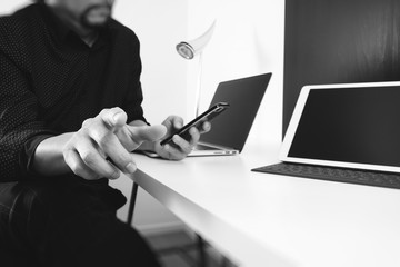 businessman working with smart phone and digital tablet and laptop computer in modern office