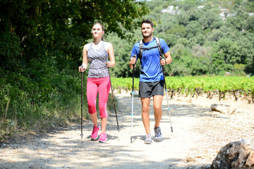 beautiful young couple sport fitness nordic walking and exercising together outdoor summer...