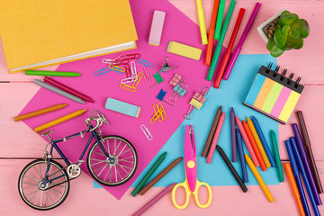 Back to school concept - school supplies: books, markers, crayons, pink and blue paper, scissors, eraser and other accessories - obrazy, fototapety, plakaty