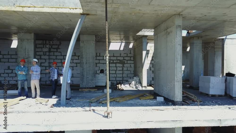 Poster aerial view of construction site and group of builders working together, team of engineers on buildi