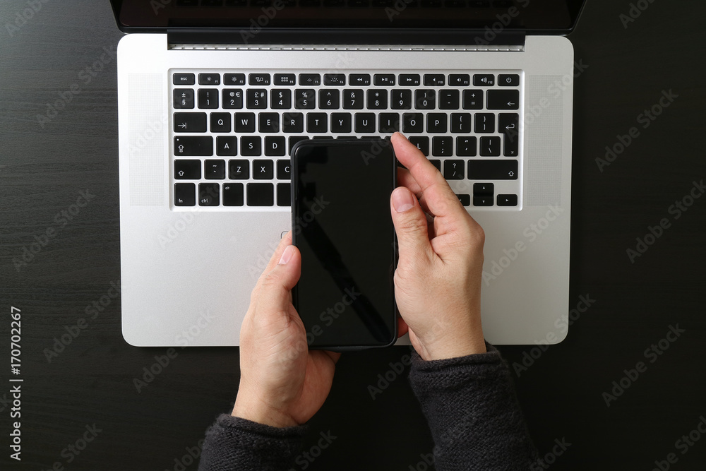 Poster cyber security internet and networking concept.Businessman hand working mobile phone on laptop computer background