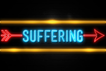 Suffering  - fluorescent Neon Sign on brickwall Front view
