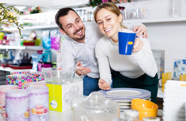 Man and woman looking at a blue cup