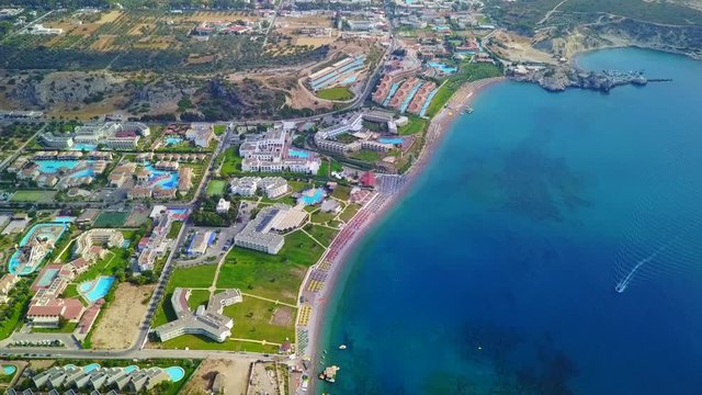 August 2017: Aerial drone video of famous pools and 5 star resorts - hotels at small village of Kolympia bay, Rhodes island, Aegean, Dodecanese, Greece