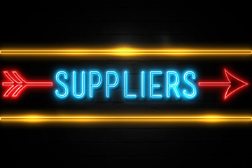 Obraz premium Suppliers - fluorescent Neon Sign on brickwall Front view