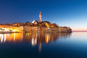 Fototapeta na wymiar Sunset at medieval town of Rovinj, colorful with houses and church