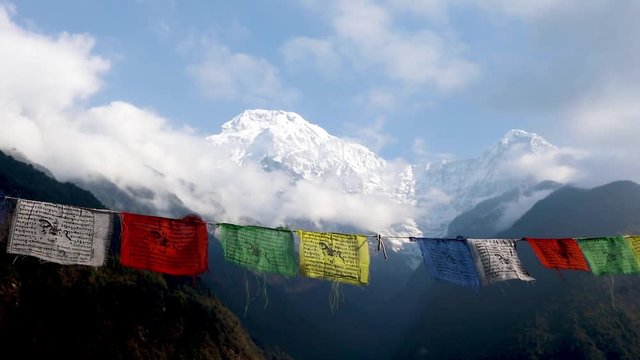 Flags with mantras against the background of the mountains of Nepal Himalayas
