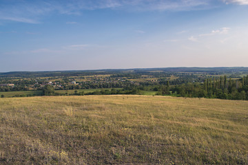 Summer sunny landscape at sunset of the day outside the city.