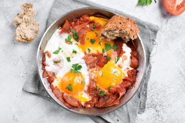 Fried eggs with bacon in frying pan