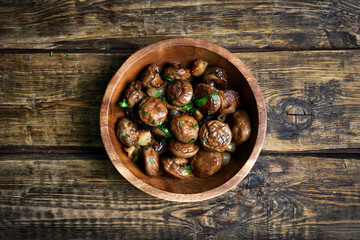 Fried mushrooms with onion in bowl, top view