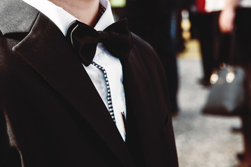 Baby boy in a tuxedo at the ceremony.